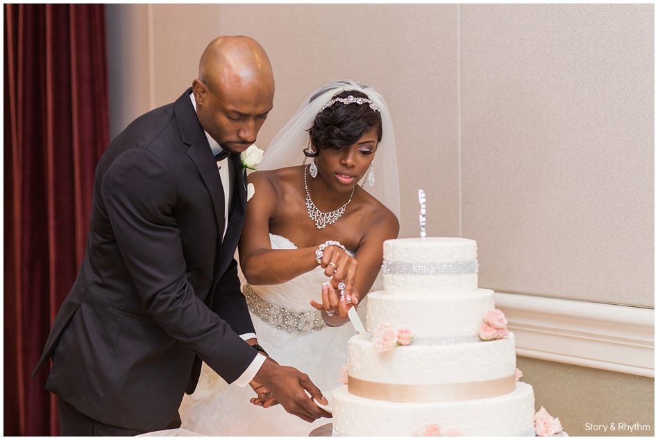 The couple cutting the cake during the reception