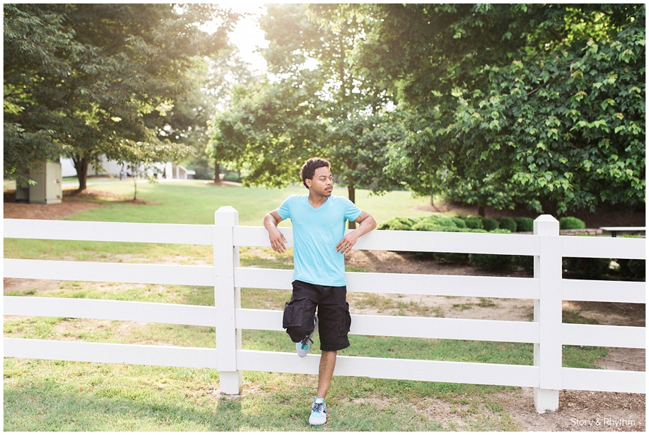 DJ posing for photo on fence