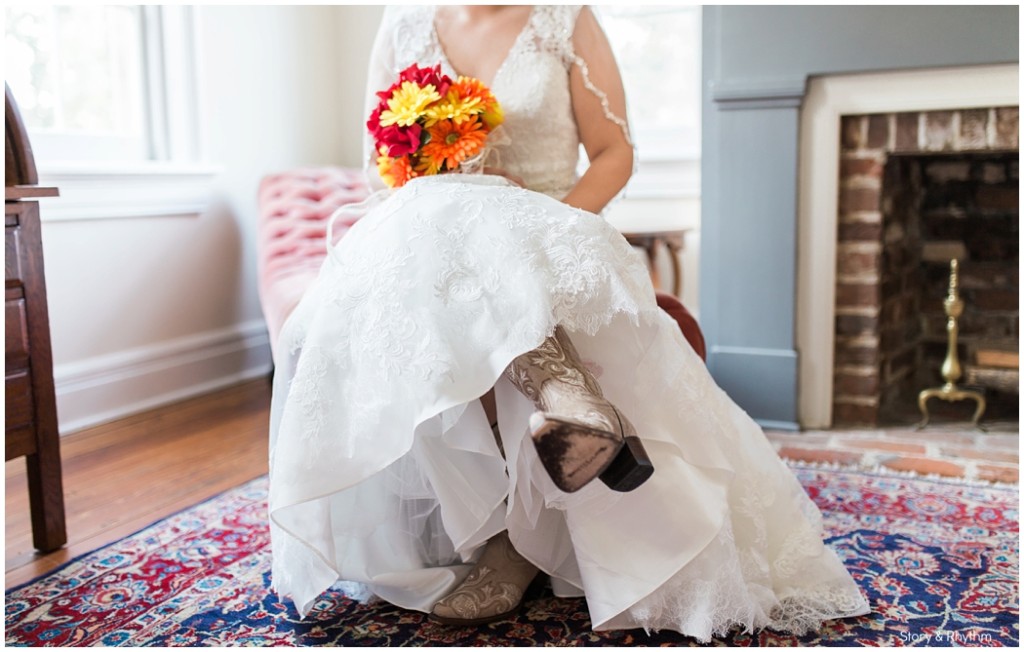 Bride wearing cowboy boots with a lace wedding dress