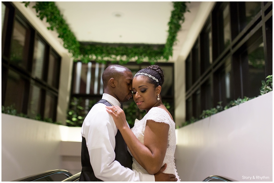 Bride and Groom posing in green hallway