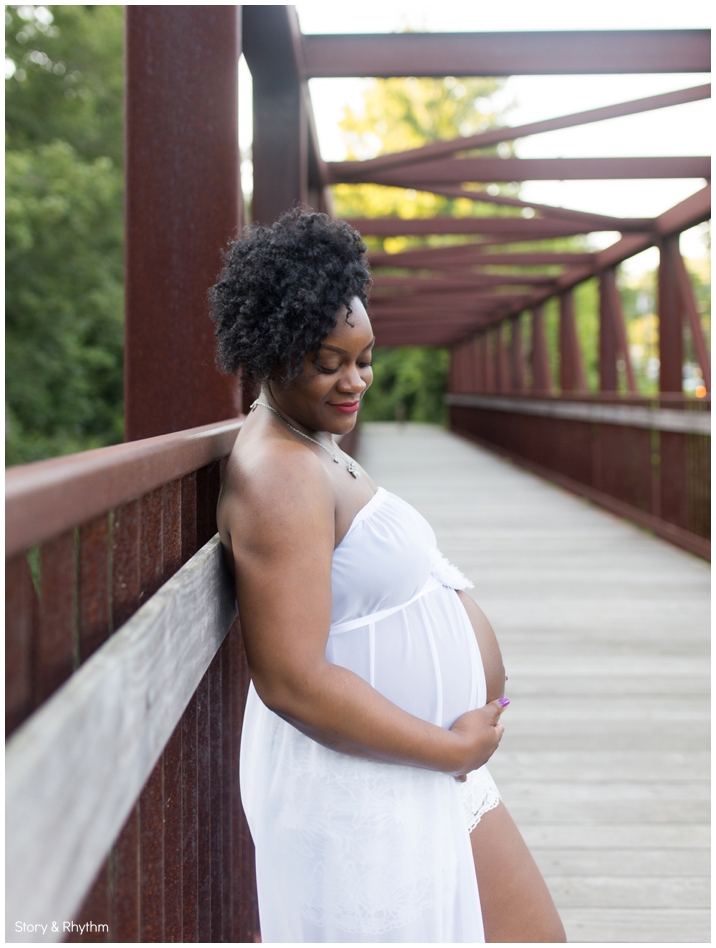 Mother to be poses on rusted bridge