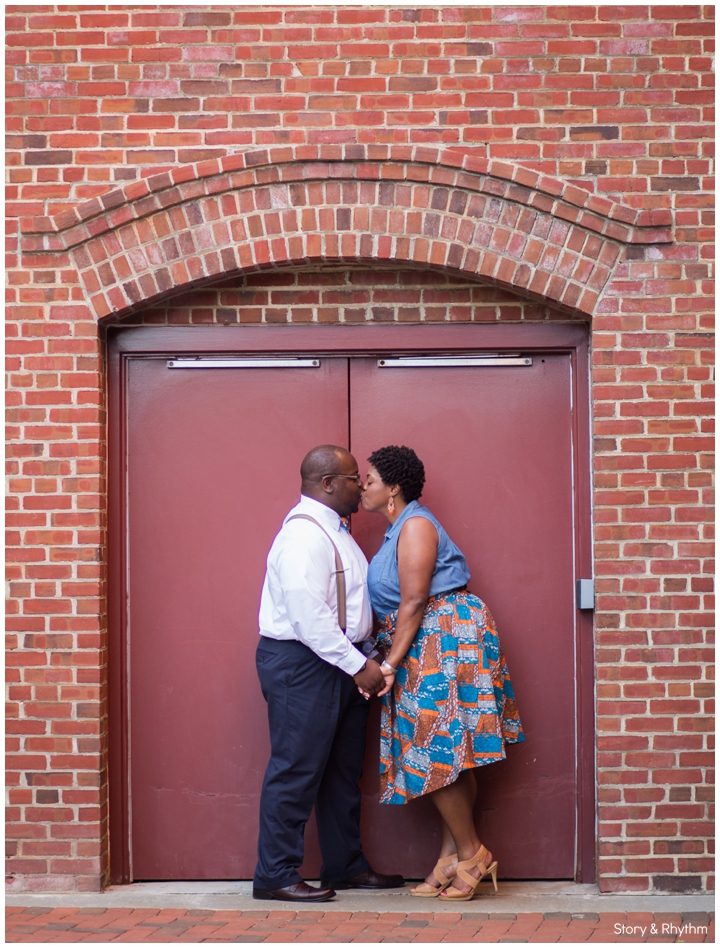 Couple kissing and holding hands at the American Tobacco District Campus