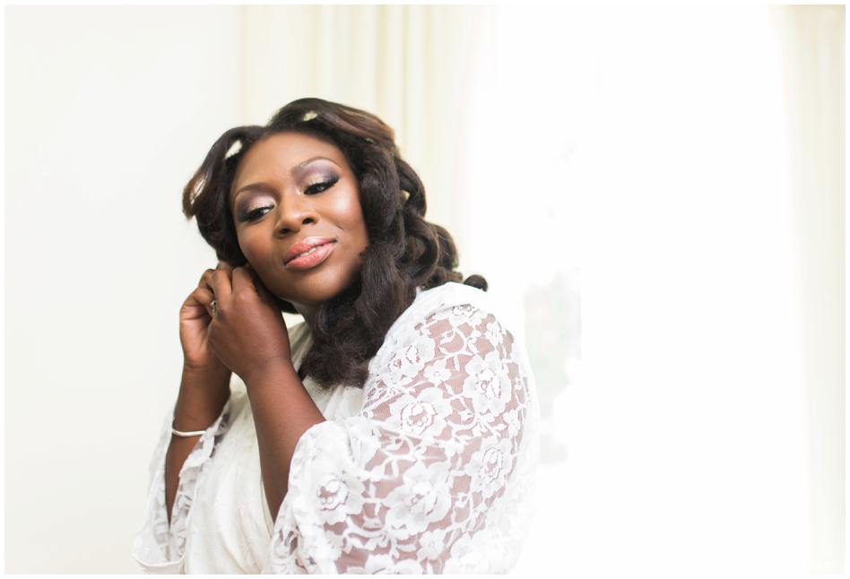 The bride putting on her earrings