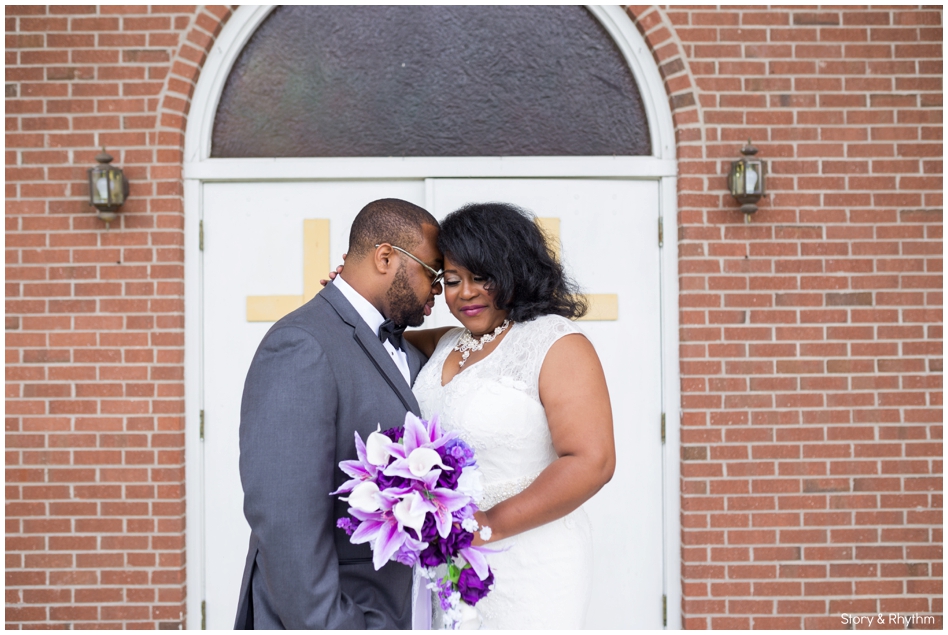 Bride and groom pose in front of Goldsboro church