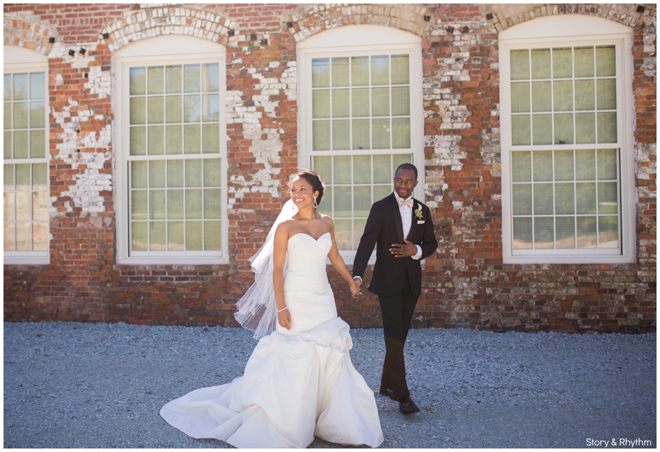 Bride and groom walking outside of The Cloth Mill at Eno River