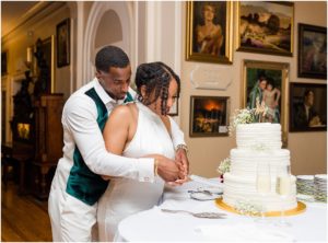 Couple cutting the cake at wedding reception